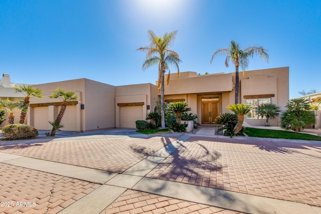 southwest-style home featuring a garage