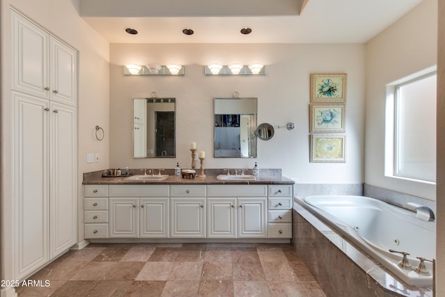 bathroom with vanity and a relaxing tiled tub