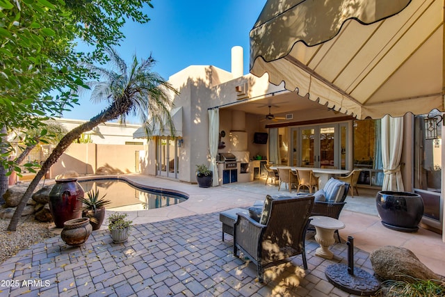 view of patio / terrace featuring a fenced in pool and a bar