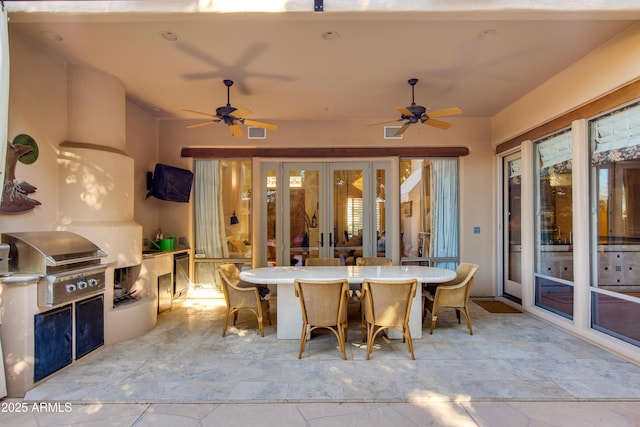 view of patio featuring french doors, ceiling fan, a grill, and exterior kitchen