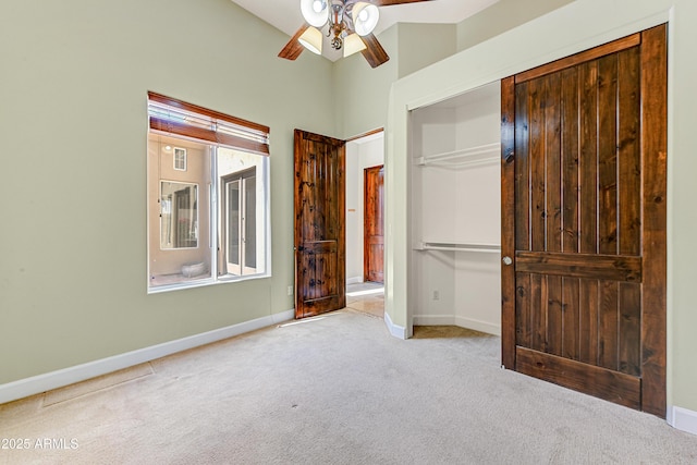 unfurnished bedroom featuring carpet floors, a closet, a ceiling fan, and baseboards