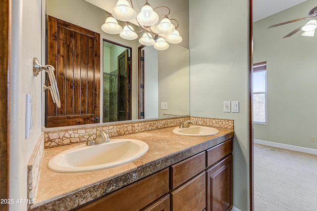 bathroom featuring double vanity, a ceiling fan, baseboards, and a sink