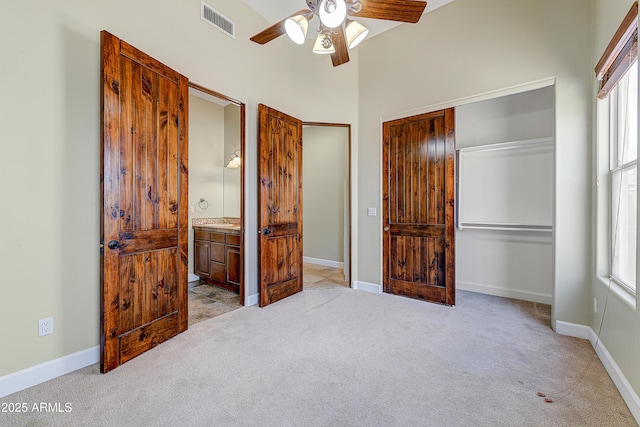 unfurnished bedroom with carpet floors, visible vents, baseboards, and a closet