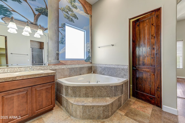 bathroom featuring vanity and a bath