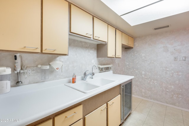 15608 N 57th Dr, Glendale, AZ 85306 - kitchen with wine cooler, light countertops, and light tile patterned flooring