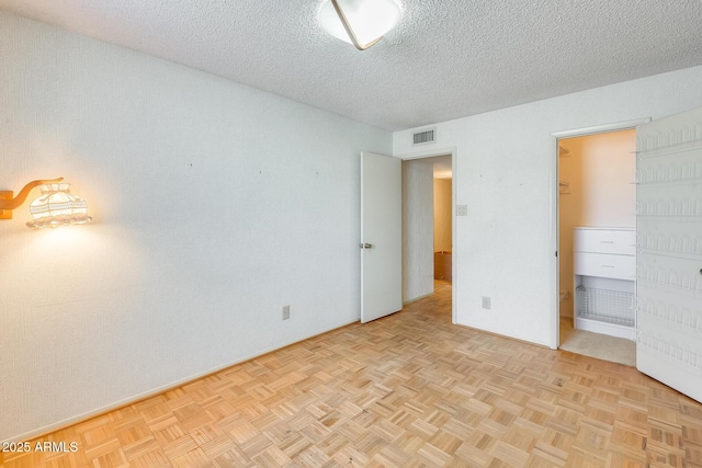 15608 N 57th Dr, Glendale, AZ 85306 - unfurnished bedroom featuring a textured ceiling and baseboards