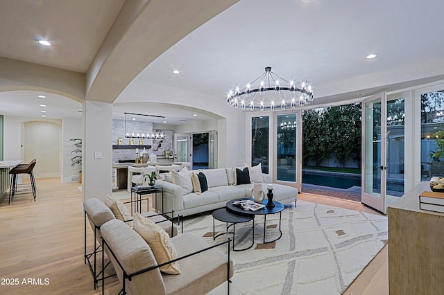 18 W Kaler Dr, Phoenix, AZ 85021 - living area featuring a chandelier, arched walkways, recessed lighting, and light wood-type flooring