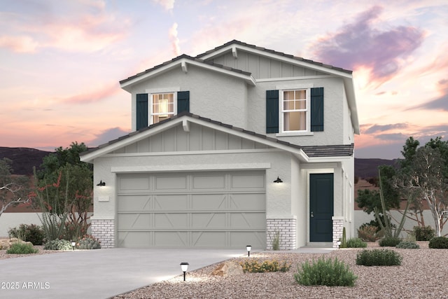 view of front facade with brick siding, board and batten siding, concrete driveway, stucco siding, and an attached garage