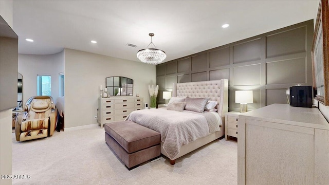 bedroom featuring light carpet and an inviting chandelier