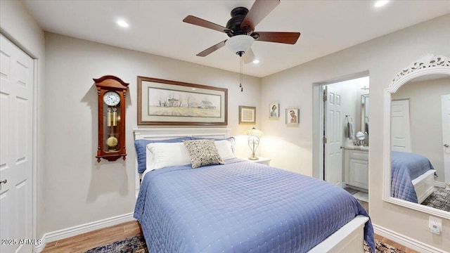 bedroom with hardwood / wood-style floors, ceiling fan, and ensuite bathroom