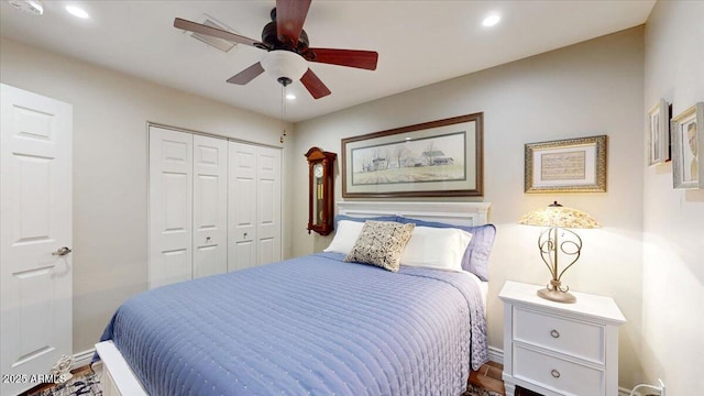 bedroom with ceiling fan and a closet