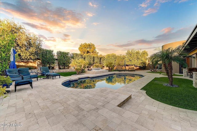 pool at dusk with a patio