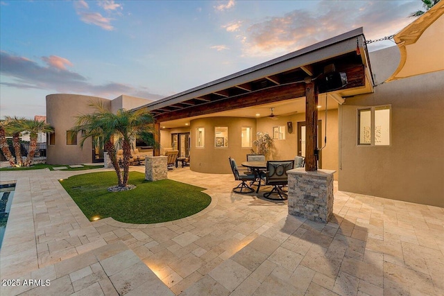 patio terrace at dusk with ceiling fan