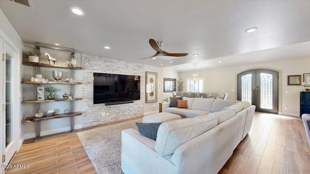 living room with french doors, ceiling fan, and light hardwood / wood-style flooring