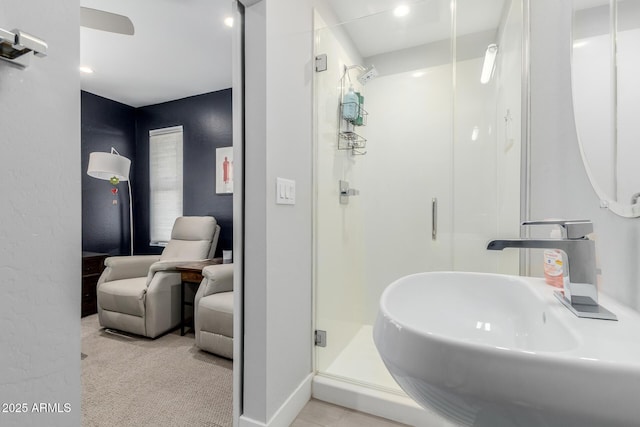 bathroom featuring a shower stall and a sink