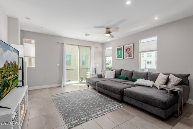 living area featuring a ceiling fan, recessed lighting, light tile patterned flooring, and baseboards