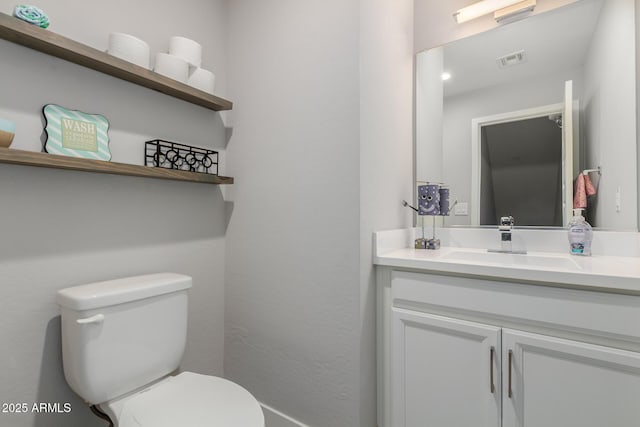 bathroom featuring vanity and toilet