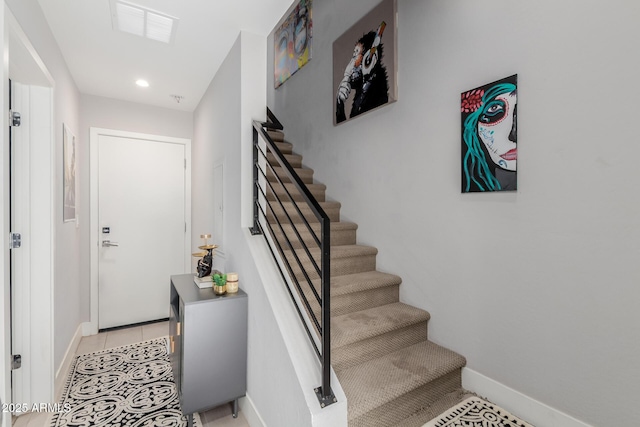 staircase featuring baseboards and recessed lighting