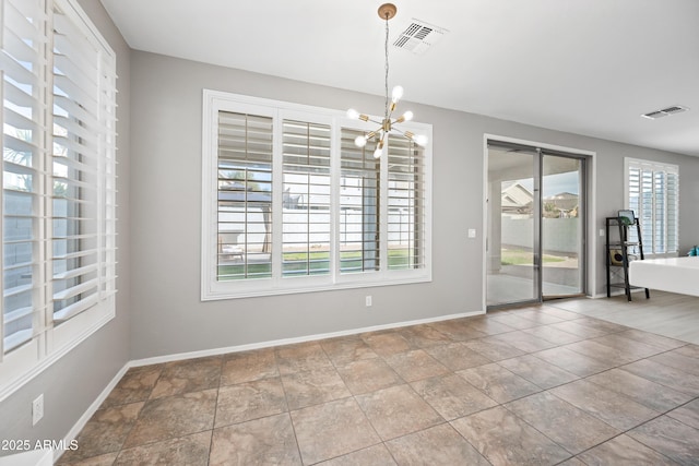 unfurnished dining area with a notable chandelier