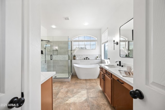 bathroom featuring vanity, independent shower and bath, and tile patterned flooring