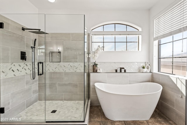 bathroom with tile patterned floors and independent shower and bath