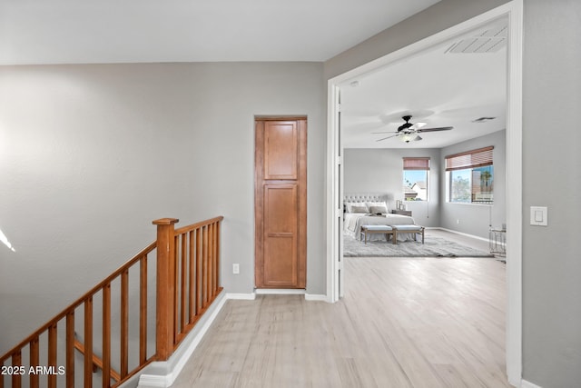 corridor with light hardwood / wood-style flooring