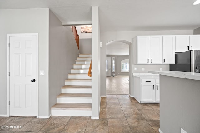 kitchen featuring white cabinetry and stainless steel fridge with ice dispenser