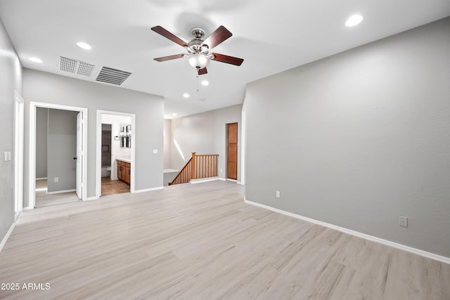 spare room featuring ceiling fan and light hardwood / wood-style flooring