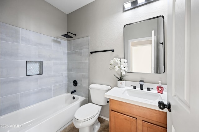 full bathroom featuring vanity, toilet, and tiled shower / bath combo