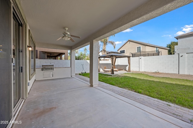 view of patio with a gazebo, ceiling fan, a grill, and exterior kitchen