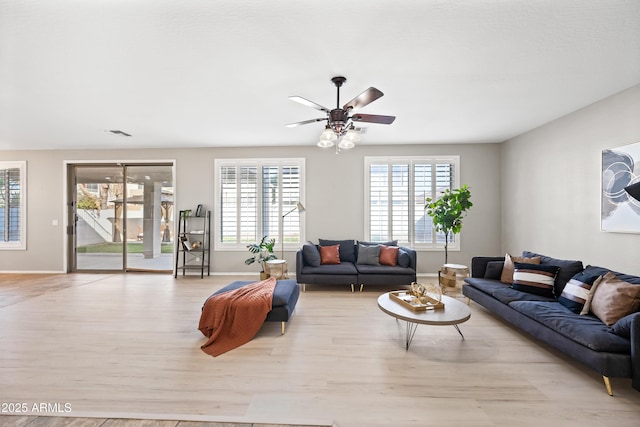 living room with ceiling fan and light hardwood / wood-style floors