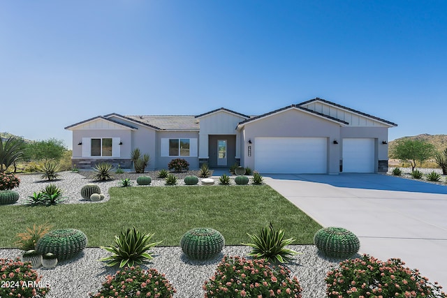 view of front of home with a garage and a front lawn