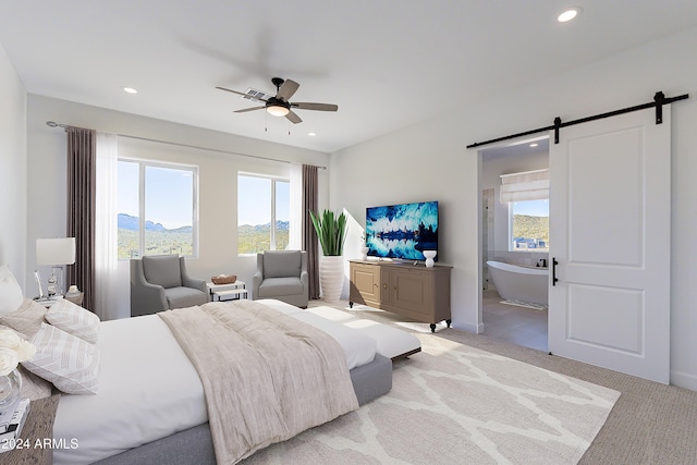 carpeted bedroom featuring ceiling fan, a barn door, and connected bathroom