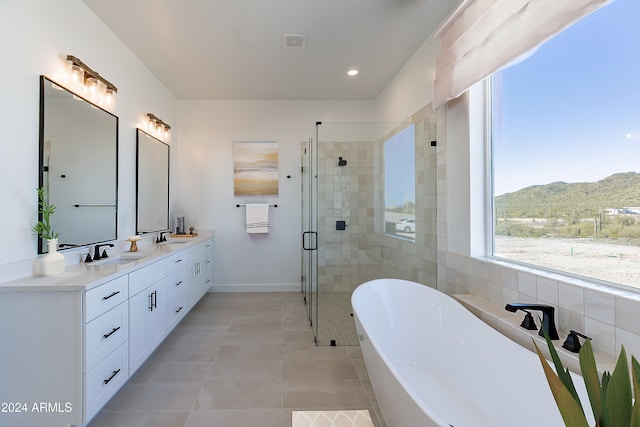 bathroom featuring tile patterned floors, vanity, a mountain view, and plus walk in shower