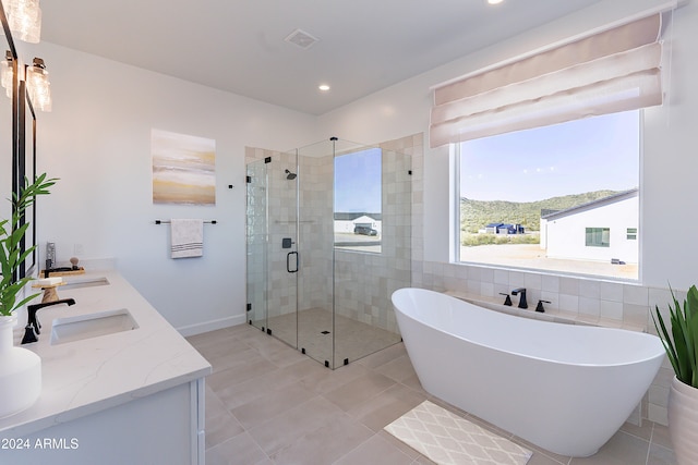 bathroom featuring tile patterned floors, a mountain view, vanity, and plus walk in shower