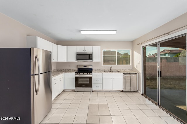 kitchen with appliances with stainless steel finishes, sink, and white cabinetry