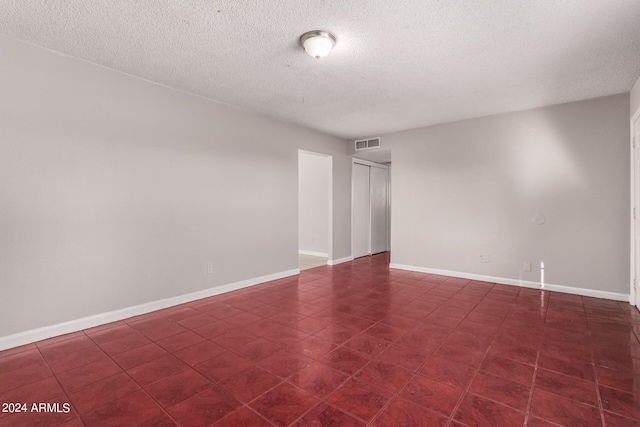 spare room with a textured ceiling