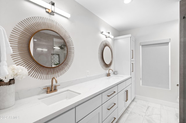bathroom featuring a sink, baseboards, double vanity, and marble finish floor