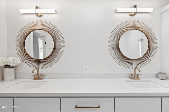 full bath featuring a sink and double vanity
