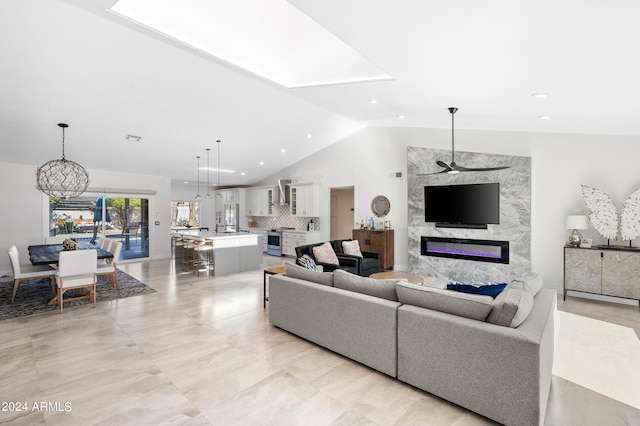 living area with high vaulted ceiling, a high end fireplace, visible vents, and recessed lighting