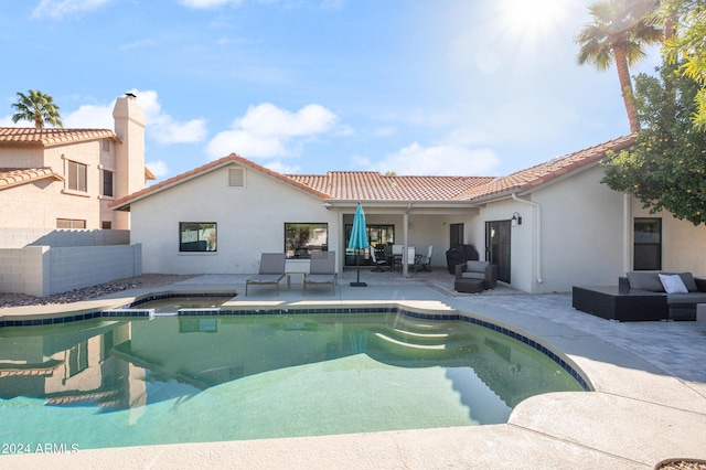 outdoor pool featuring a patio, an outdoor living space, and fence