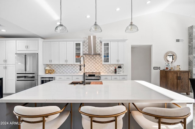 kitchen with freestanding refrigerator, wall chimney range hood, beverage cooler, lofted ceiling, and decorative backsplash