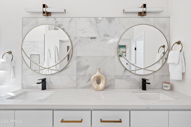 bathroom featuring double vanity, a sink, and decorative backsplash