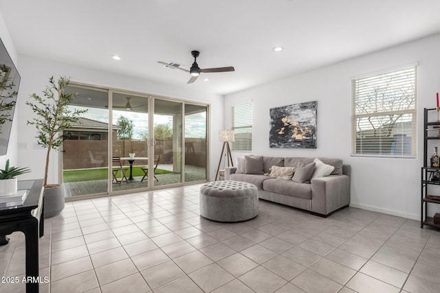 living room with light tile patterned flooring, recessed lighting, baseboards, and ceiling fan