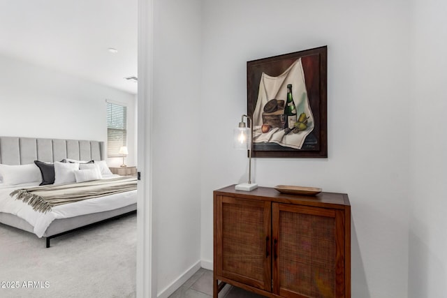 tiled bedroom with carpet flooring and baseboards