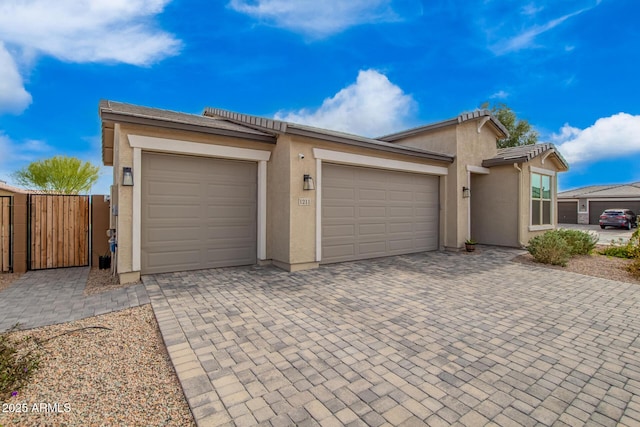 exterior space featuring decorative driveway and a gate