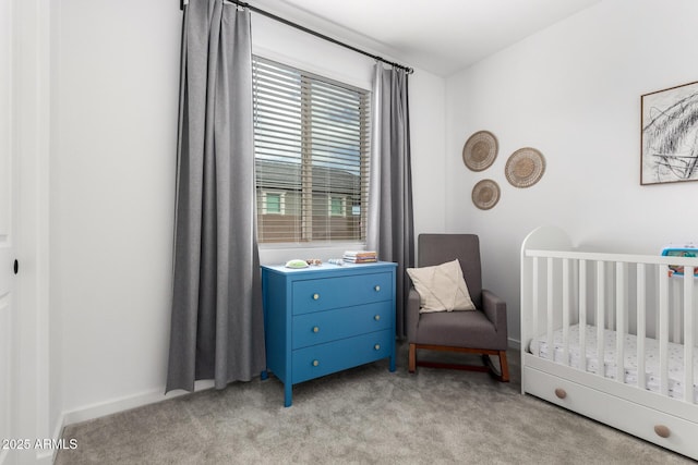 bedroom with a crib and light carpet