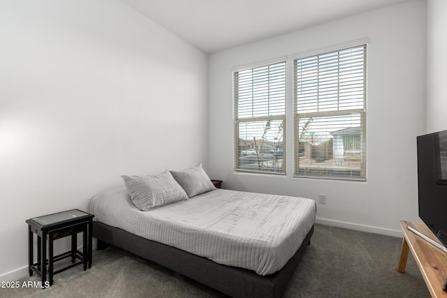 carpeted bedroom featuring baseboards and lofted ceiling