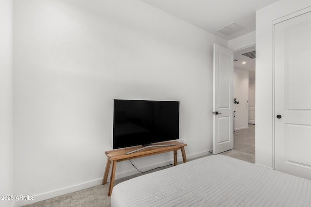 carpeted bedroom with visible vents and baseboards