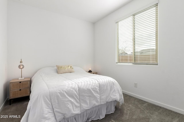 bedroom with baseboards and carpet